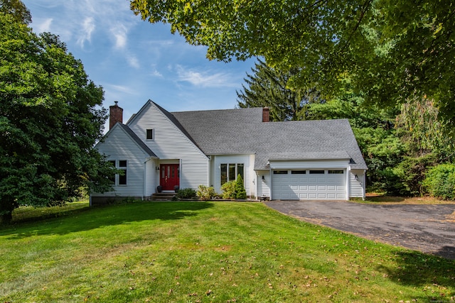 view of front of property featuring a front yard and a garage