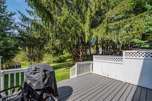 deck featuring grilling area and a yard