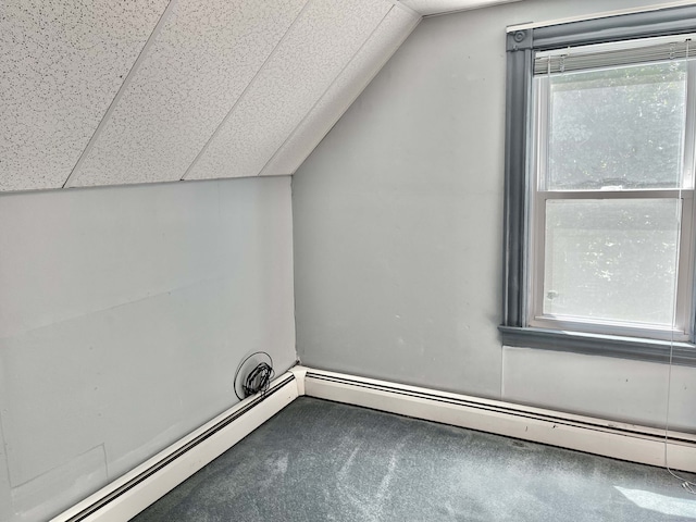 additional living space with carpet flooring, lofted ceiling, and a baseboard radiator