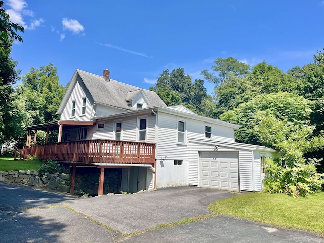 view of home's exterior featuring a lawn and a deck