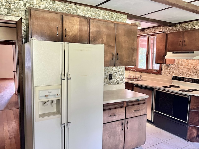 kitchen with light hardwood / wood-style flooring, sink, white appliances, and tasteful backsplash