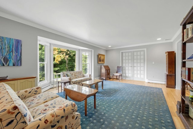 living room with ornamental molding, light wood-type flooring, and a baseboard heating unit