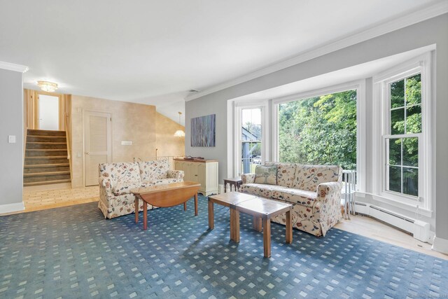 living room featuring ornamental molding, a baseboard heating unit, and plenty of natural light