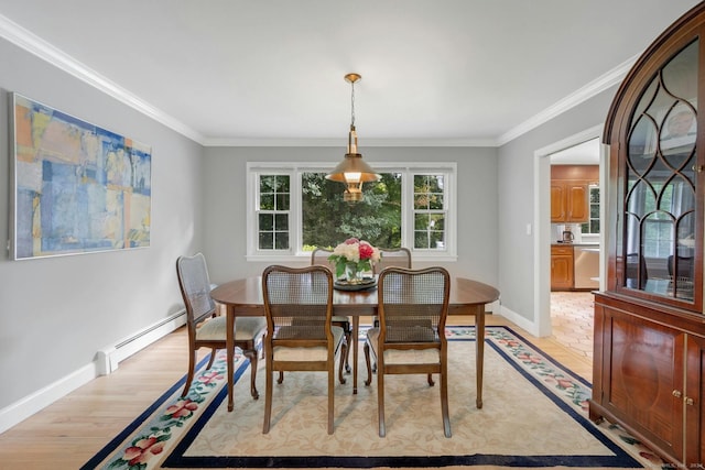 dining space with light wood-type flooring, crown molding, and a baseboard radiator