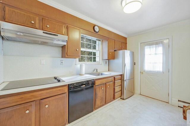 kitchen featuring a healthy amount of sunlight, black appliances, ornamental molding, and sink