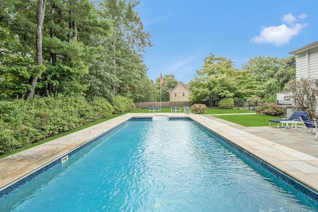 view of swimming pool featuring a lawn and a patio area