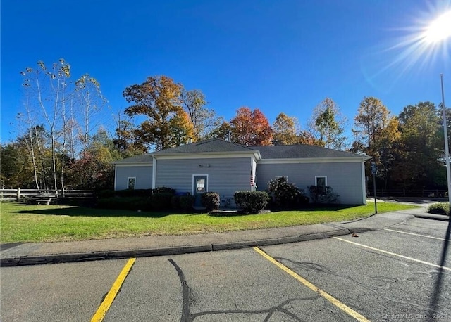 view of side of home with a lawn