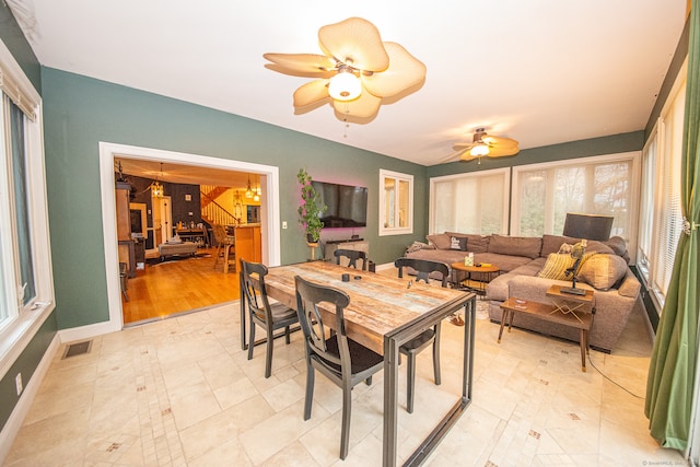 dining space with light wood-type flooring and ceiling fan