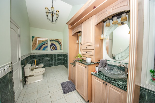 bathroom featuring toilet, tile patterned flooring, a bidet, vaulted ceiling, and vanity