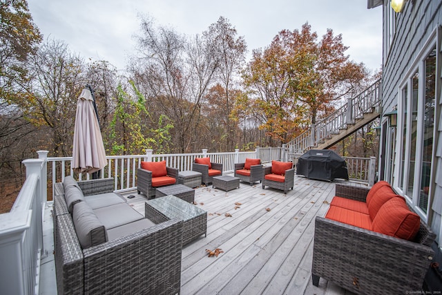 wooden terrace featuring a grill and an outdoor hangout area