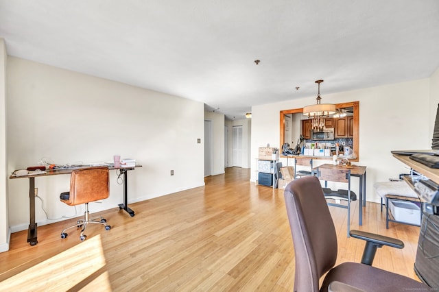 office featuring light hardwood / wood-style floors and a chandelier