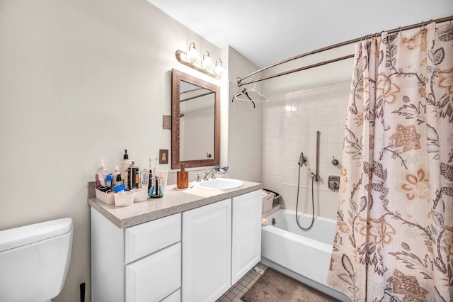 full bathroom with shower / bath combo with shower curtain, tile patterned floors, vanity, and toilet