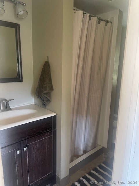 bathroom with vanity and walk in shower