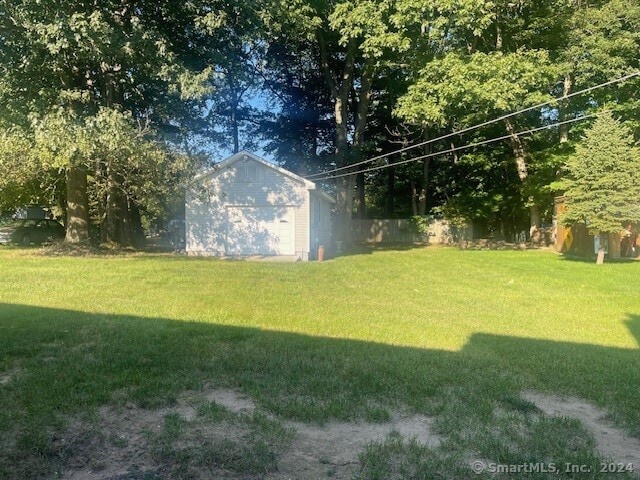 view of yard with a garage and an outdoor structure