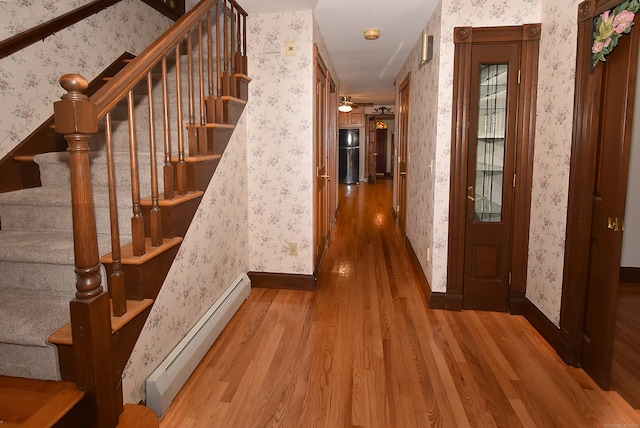 hallway featuring light hardwood / wood-style flooring and baseboard heating