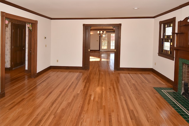 interior space featuring light hardwood / wood-style floors, ornamental molding, and a chandelier