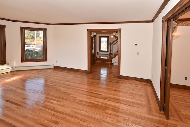 unfurnished room with ornamental molding and light wood-type flooring