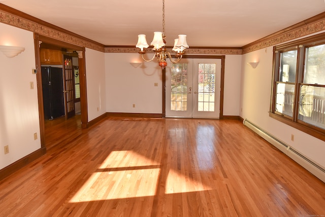 spare room with french doors, a baseboard heating unit, crown molding, light wood-type flooring, and a chandelier