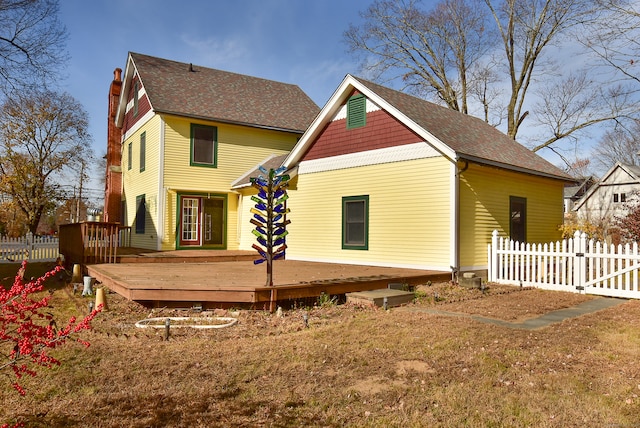 rear view of house featuring a wooden deck