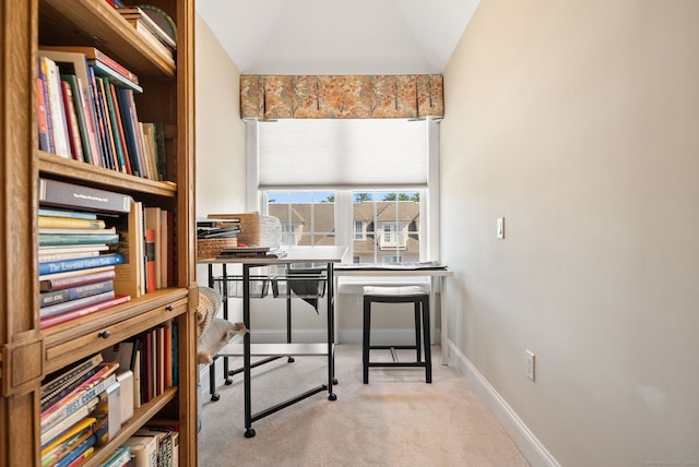 office featuring vaulted ceiling and light colored carpet