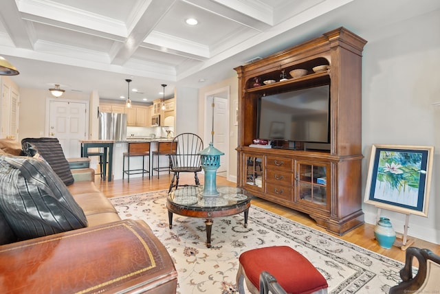 living room featuring light hardwood / wood-style floors, coffered ceiling, beamed ceiling, and ornamental molding