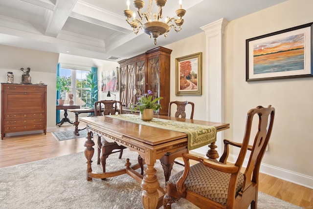 dining space with a chandelier, light hardwood / wood-style flooring, beamed ceiling, crown molding, and coffered ceiling