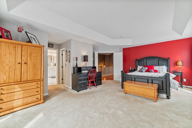 carpeted bedroom featuring a raised ceiling