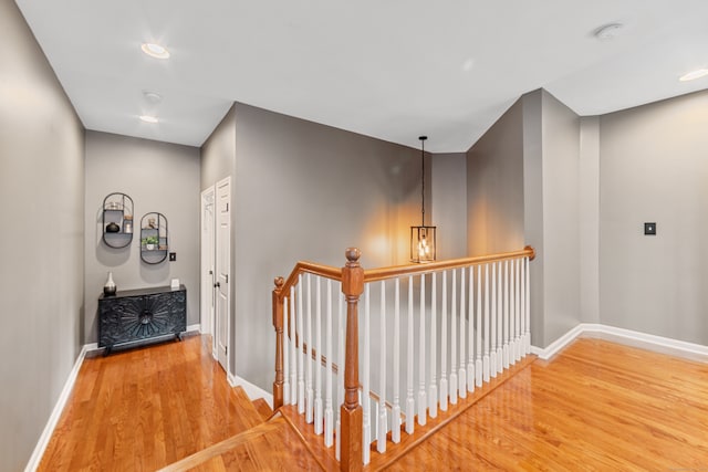 hallway with hardwood / wood-style floors