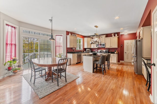 dining area featuring light wood-type flooring and sink