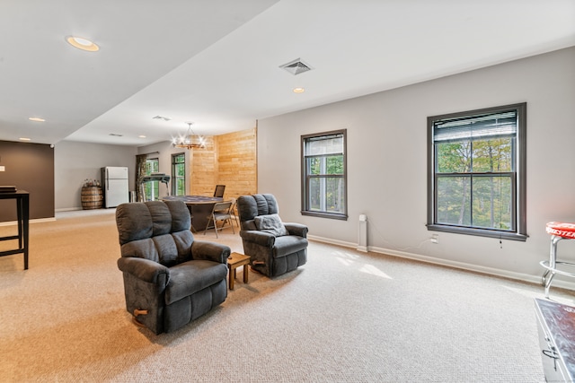 living room featuring an inviting chandelier and carpet floors