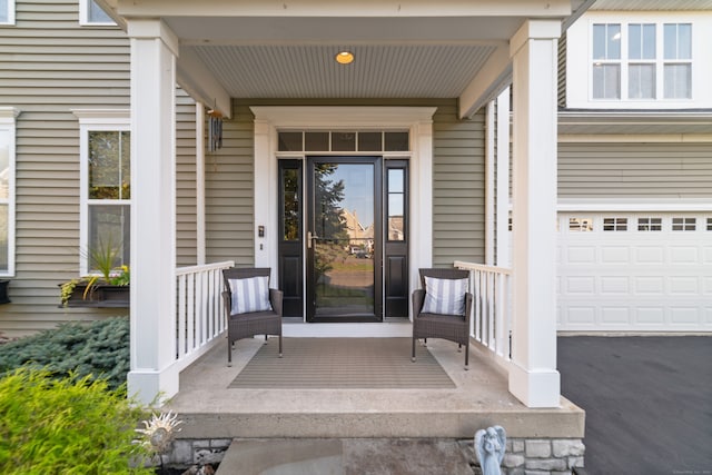 property entrance with a garage and a porch