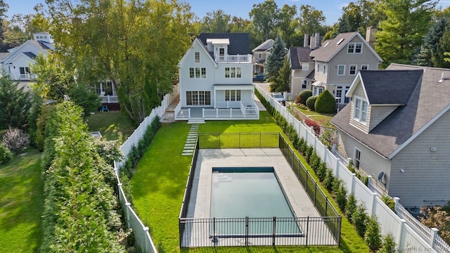 exterior space featuring a lawn and a fenced in pool