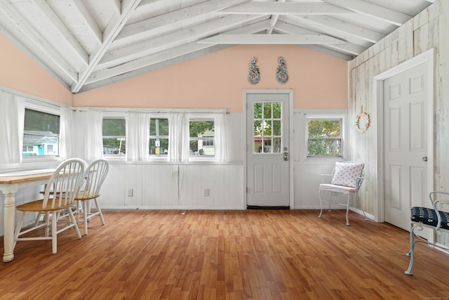 interior space featuring lofted ceiling with beams and light hardwood / wood-style floors