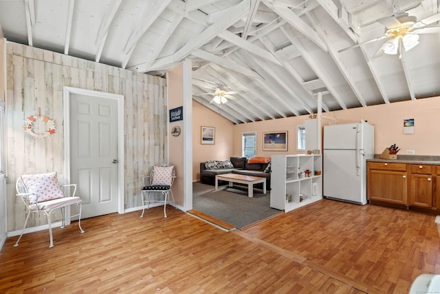 interior space featuring light hardwood / wood-style floors, ceiling fan, and beamed ceiling