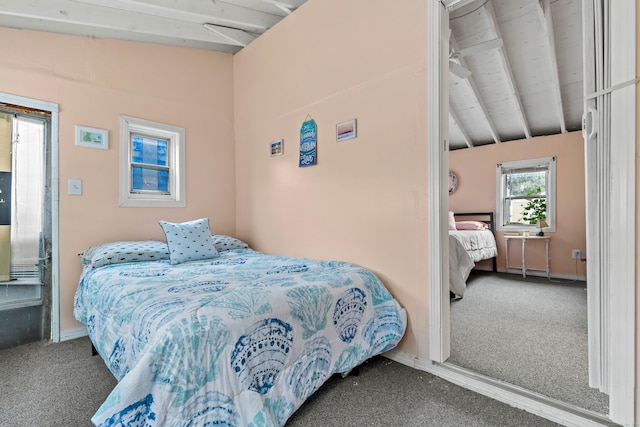 carpeted bedroom with lofted ceiling with beams