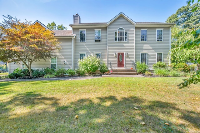 colonial house featuring a front lawn