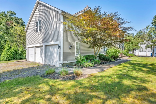 view of home's exterior featuring a lawn and a garage