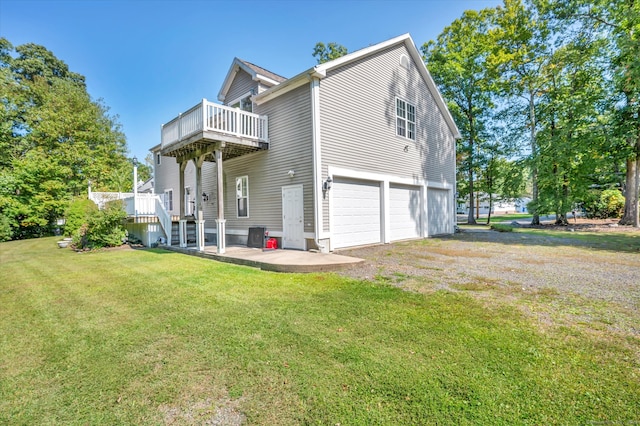 view of side of home featuring a lawn and a garage