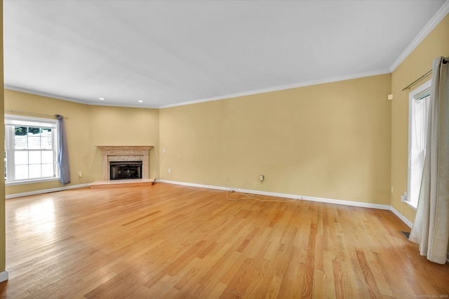 unfurnished living room with ornamental molding and light hardwood / wood-style floors