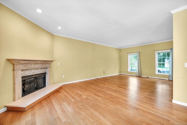 unfurnished living room featuring a fireplace, light wood-type flooring, and crown molding