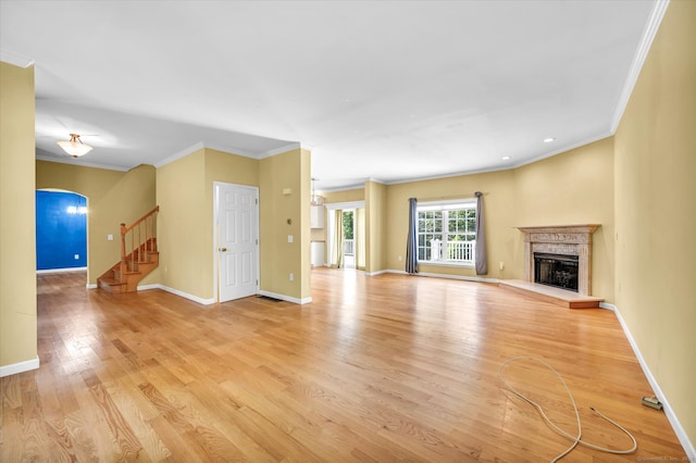 unfurnished living room featuring crown molding and light hardwood / wood-style floors