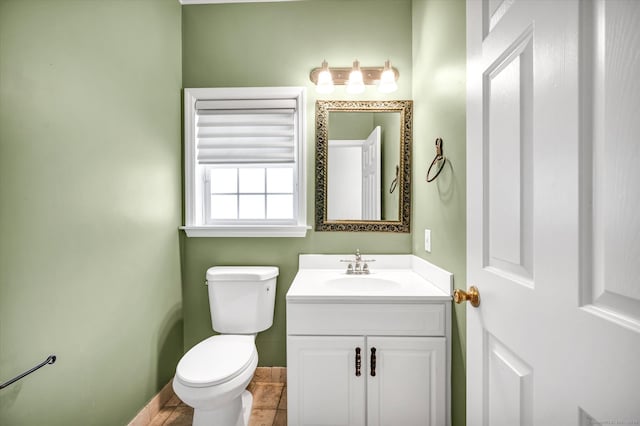 bathroom with vanity, tile patterned flooring, and toilet