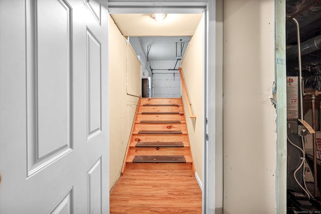 stairs featuring hardwood / wood-style floors