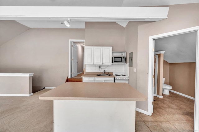 kitchen featuring electric range, tasteful backsplash, sink, white cabinetry, and light carpet