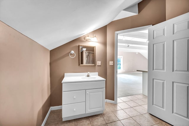 bathroom featuring vaulted ceiling, vanity, and tile patterned floors