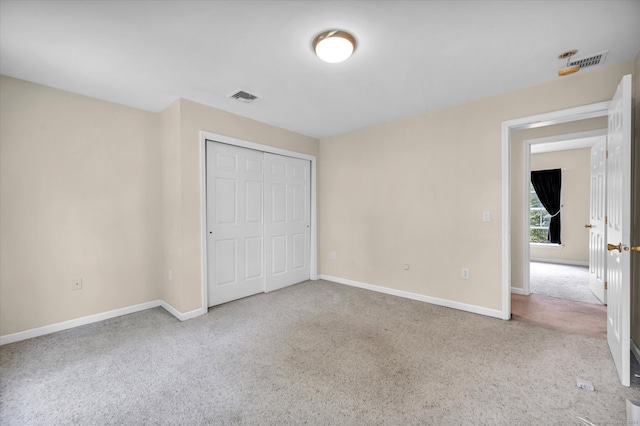 unfurnished bedroom with carpet flooring and a closet