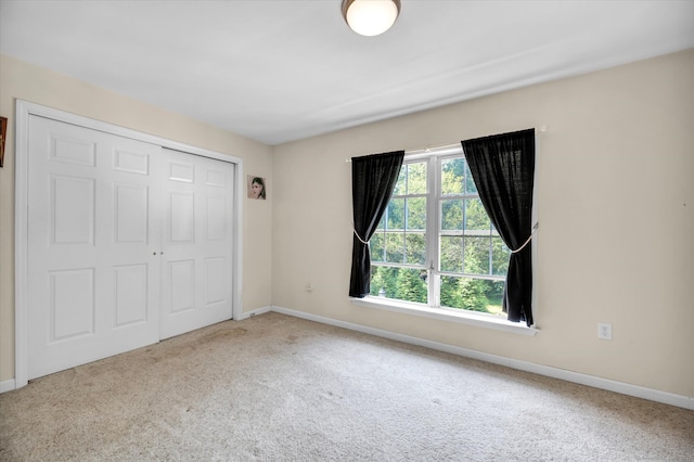 unfurnished bedroom with a closet and carpet