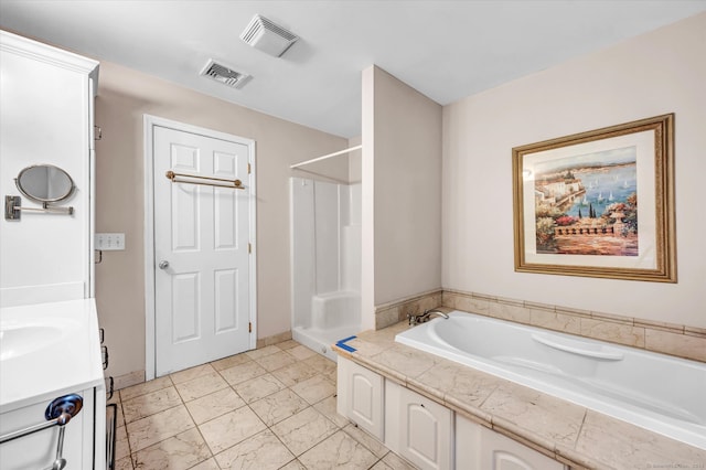 bathroom featuring independent shower and bath and vanity