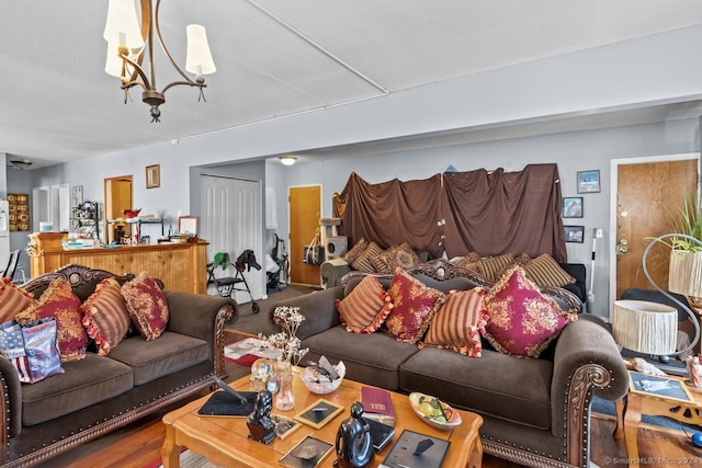 living room featuring an inviting chandelier and hardwood / wood-style flooring