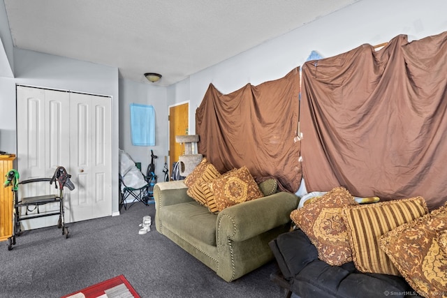 living room with a textured ceiling and dark carpet